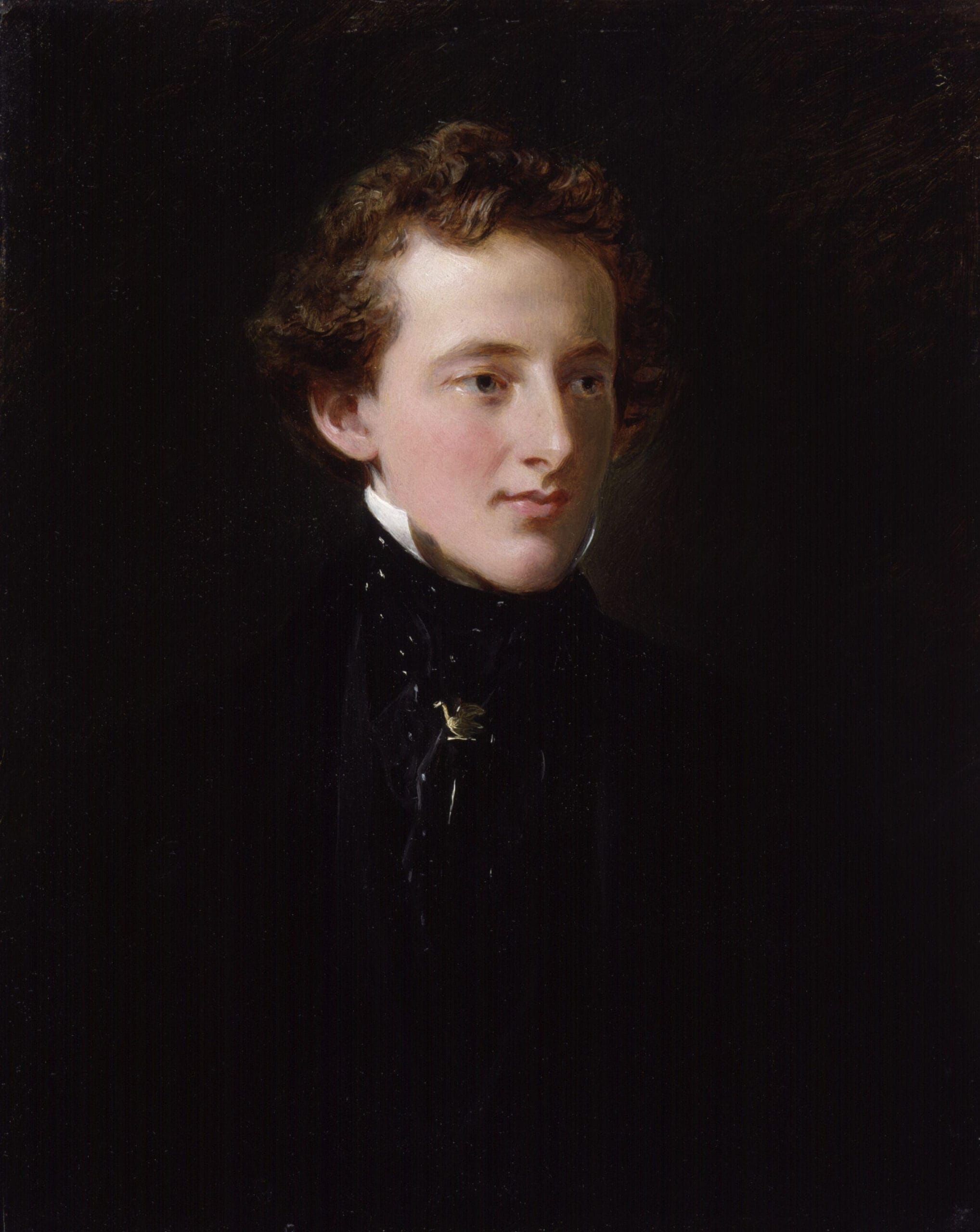A young man with curly brown hair gazes to the left in a classic portrait. He wears a formal black suit and white collar, exuding a calm, pensive demeanor.
